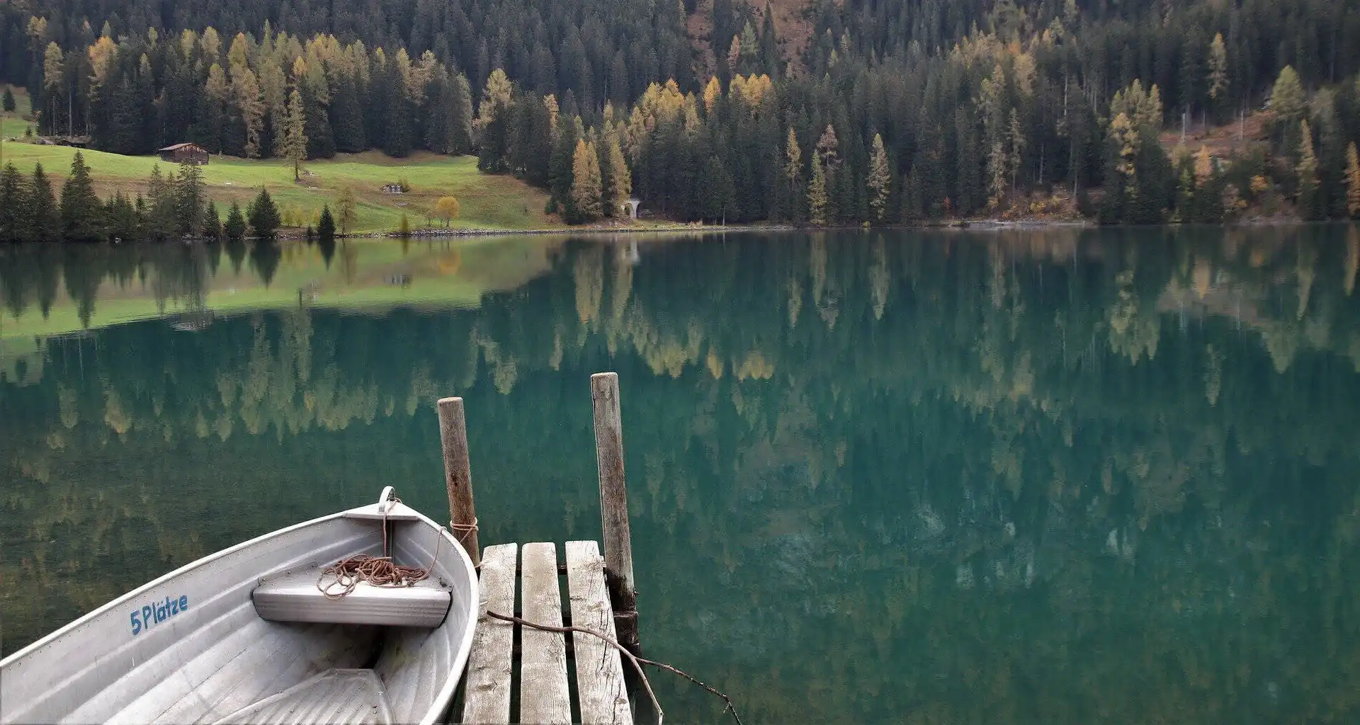 Placid lake with a boat at the dock
